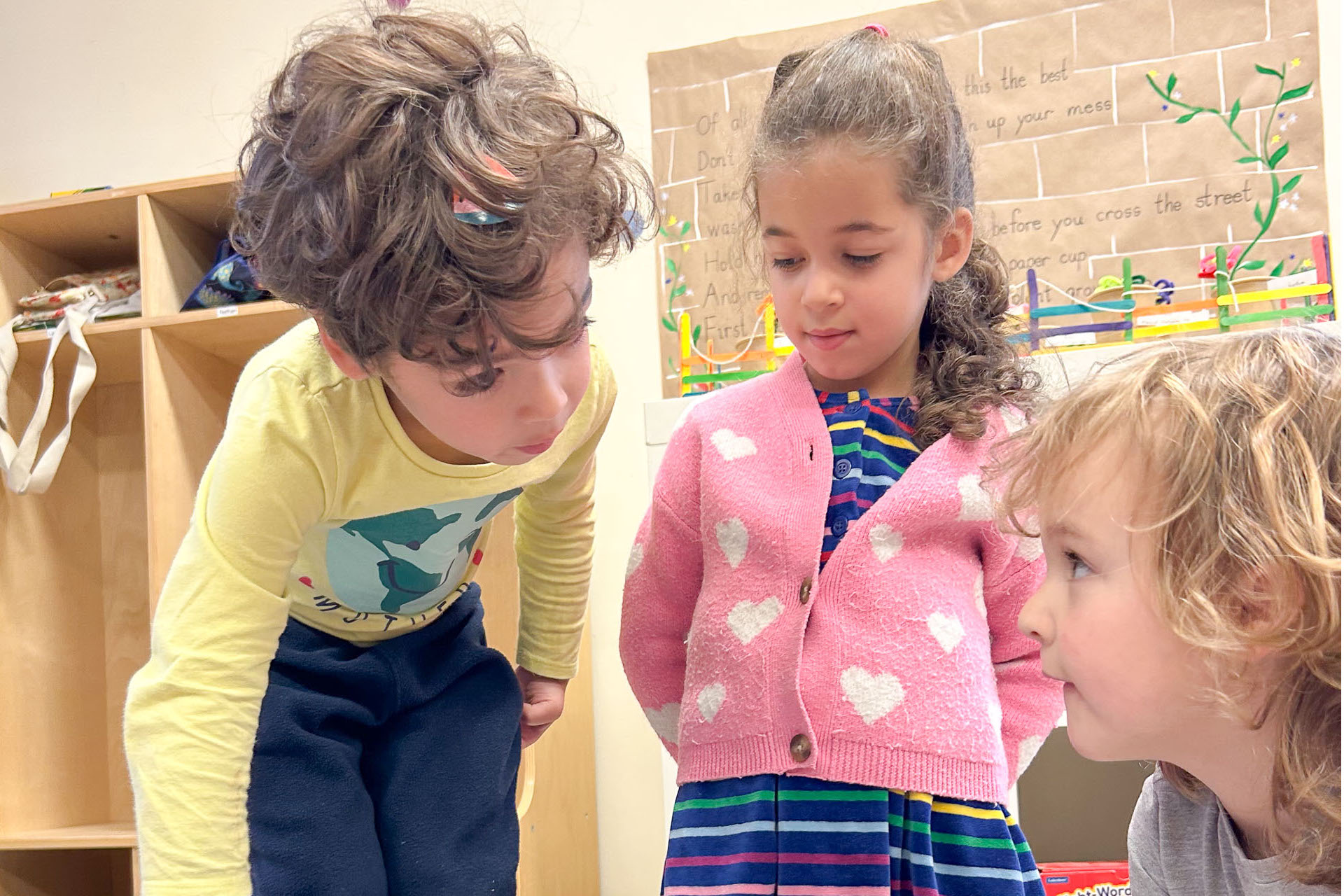 Students pointing at floor